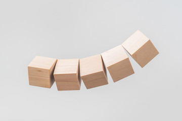 Abstract floating wooden dice on white background