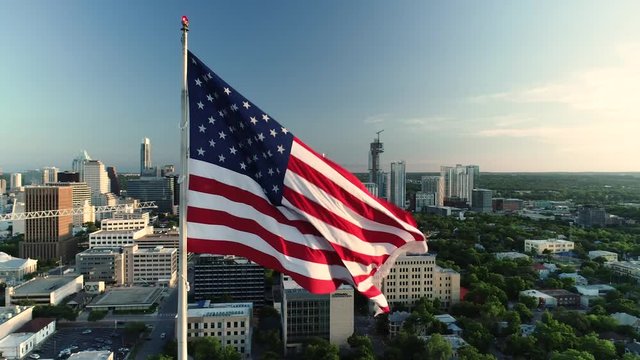 4K Orbiting Aerial American Flag Austin in Background
