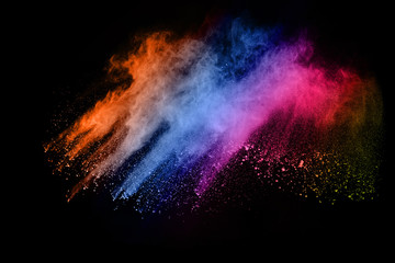 abstract colored dust explosion on a black background.abstract powder splatted background,Freeze motion of color powder exploding/throwing color powder, multicolored glitter texture.