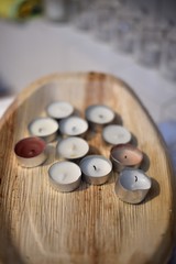 White candles in wooden tray