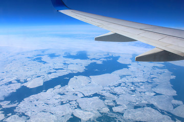 Flight on the plane over the sea. Top view from the window. Background. Landscape.
