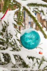 Christmas toy hanging on the tree outside in winter