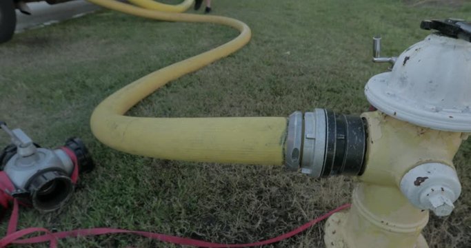 Yellow firehose on a fire hydrant