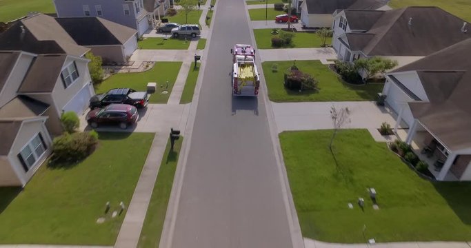 Aerial of firetruck driving through neighborhood