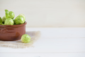 a pile of Brussels sprouts on a white background with copy space