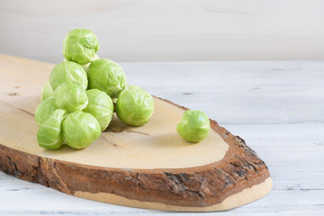a pile of Brussels sprouts on a white wooden background