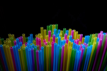 colored cocktail tubes on a dark background