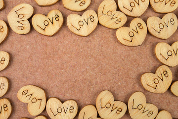 Many wooden natural hearts with an inscription love
