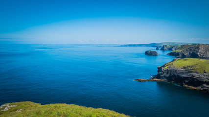 Green rocky cliffs, dramatic landscape with Atlantic Ocean / Celtic Sea view from Tintagel castle...
