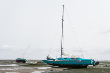 sailing boat  stuck on the bottom of the bay during the tide