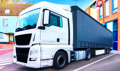 the truck in the city .Truck on the road . Commercial transport . truck transport container