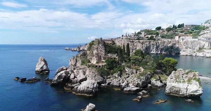 Panoramic aerial view of Cefalu sea port and Tyrrhenian Sea coast, Sicily, Italy. Cefalu city is one of the major tourist attractions in the region. View from Rocca di Cefalu. 4K, 50fps, slowmotion