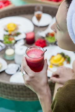 Close up image of a woman drinking detox juice, a healthy breakfast as a good start of a day