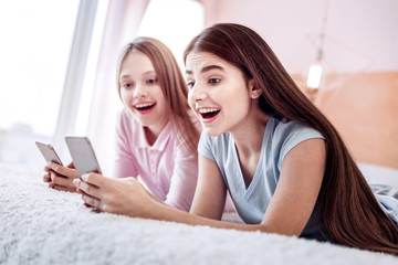 Inspired two girls receiving message from guy