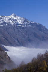 The clouds under the Rocciamelone Italy may look like a white river flowing among the mountains.