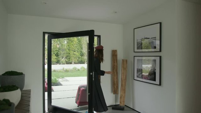 Woman coming back home from a trip / traveling 