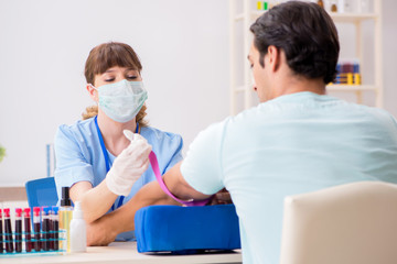 Fototapeta premium Young patient during blood test sampling procedure 