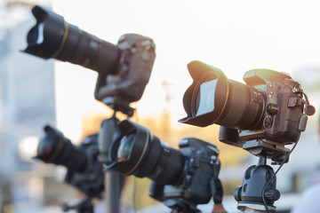 Professional modern DSLR camera on  tripod,Many DSLR cameras on a tripod, Closeup of a camera on tripod outdoors