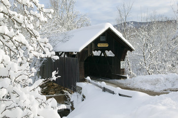 A snow blanketed Emily's covered bridge in Stowe Vermont, USA - Powered by Adobe