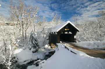 Covered bridged blanketed in fresh snow on a sunny winter morning.