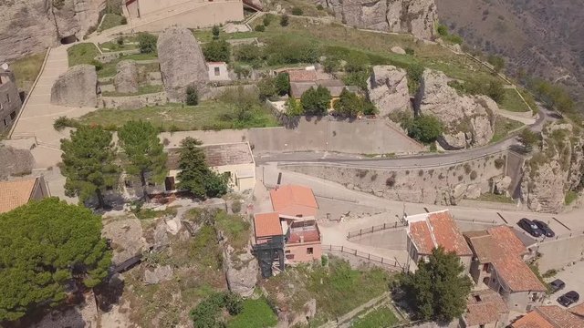 Stunning riseup 4k drone aerial footage towards the rock and cross in Bova, a small Italian village in the hills in Calabria