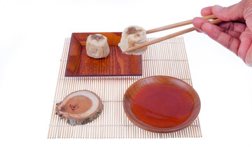 A man holding Dim Sum Chinese Dumplings using chopstick isolated on white background, with clipping path .