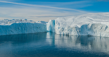 Iceberg aerial photo - giant icebergs in Disko Bay on greenland floating in Ilulissat icefjord from melting glacier Sermeq Kujalleq Glacier, aka Jakobhavns Glacier. Global warming and climate change