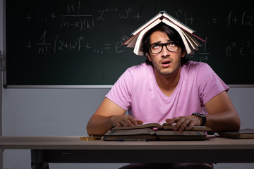 Young male student sitting in classroom