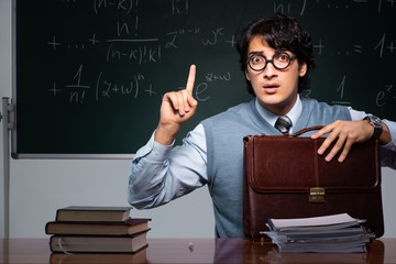 Young math teacher in front of chalkboard