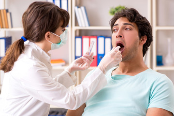 Doctor getting saliva test sample in clinic hospital - obrazy, fototapety, plakaty