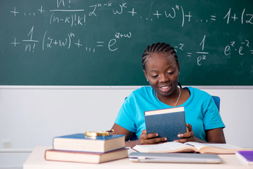 Black female student in front of chalkboard  