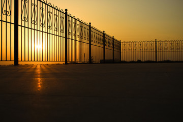 Silhouette of fence during sunset