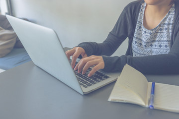 Asian business staff working on laptop to chat with customer