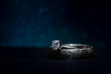 Wedding rings on a blue background with misty bokeh 