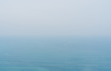 Blue sea with mist and overcast sky, mystery environment over ocean