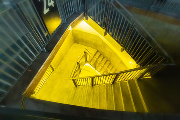Street urban staircase with yellow illumination leading underground.