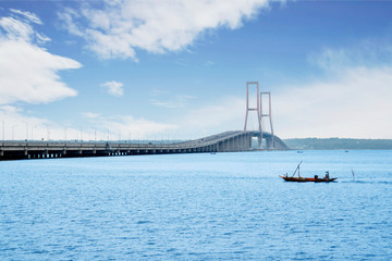 Fototapeta na wymiar Madura strait with Suramadu bridge under blue sky