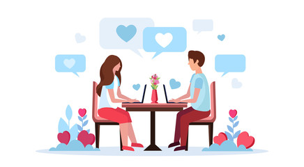 Couple sitting at table using laptop happy