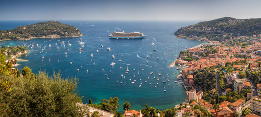 View overlooking the harbour at Villefranche-sur-mer with many yachts and a luxury cruiseliner visible