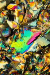 Abstract micrograph of colorful crystals of the amino acid phenylalanine.