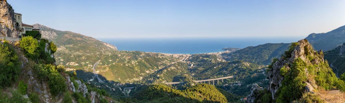 Panoramic view of Menton and the surrounding hillside buildings in front of the A8 bridge road, as captured from Sainte Agnes