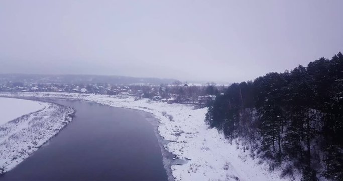 Flight over the river. Winter. Taiga. Church.