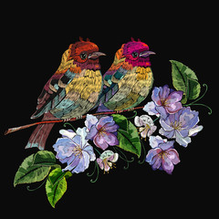 Embroidery two birds on branch, spring violet flowers. Fashion template for clothes, textiles and t-shirt design