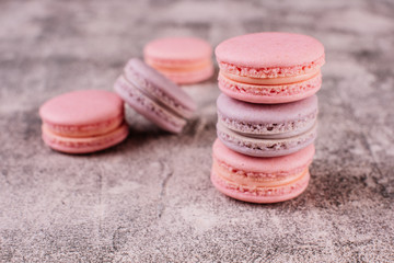 Wedding, St. Valentine's Day, birthday, preparation, holiday. Beautiful pink tasty macaroons on a concrete background