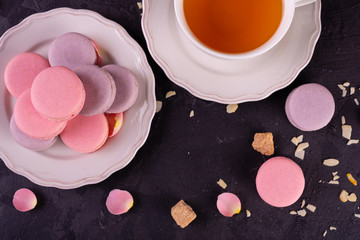 Wedding, St. Valentine's Day, birthday, preparation, holiday. Beautiful pink tasty macaroons on a concrete background