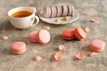 Wedding, St. Valentine's Day, birthday, preparation, holiday. Beautiful pink tasty macaroons on a concrete background