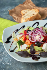 Greek salad with fresh vegetables, feta cheese and black olives