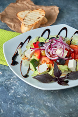 Greek salad with fresh vegetables, feta cheese and black olives