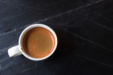 a cup of latte art coffee on wooden background