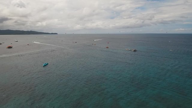 aerial view water sports and recreation on tropical island, jet ski, parasailing and boat. Philippines Boracay, aerial footage